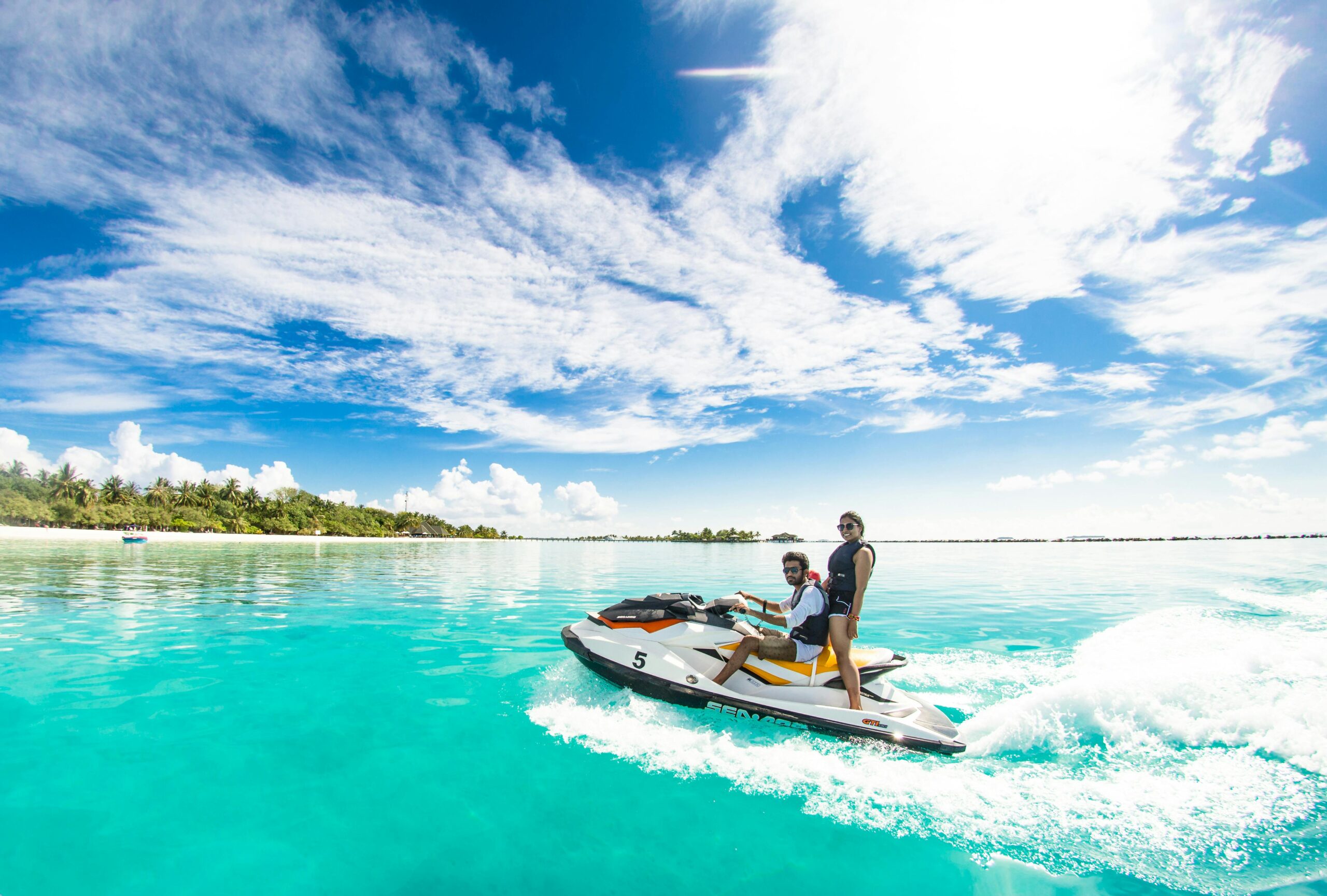 A couple enjoying their jet ski bought on finance
